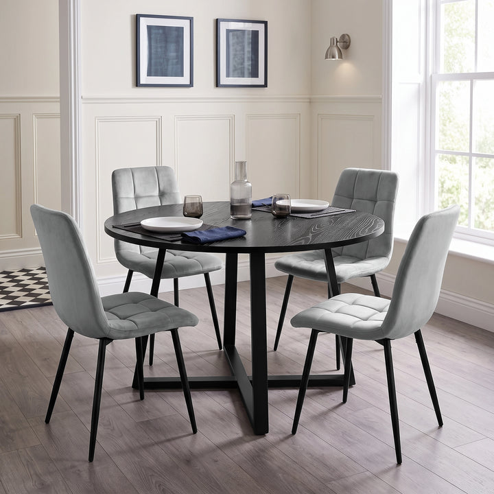 [Light Grey | Black Wood] Kyvon round dining table set in panelled dining room with four light grey velvet chairs