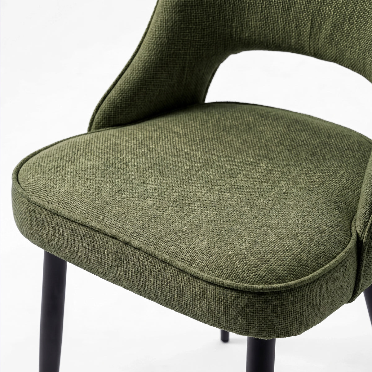 [Green | Tinted] Close-up of the 4 seater Kyvon green upholstered fabric comfy chair seat with black metal legs