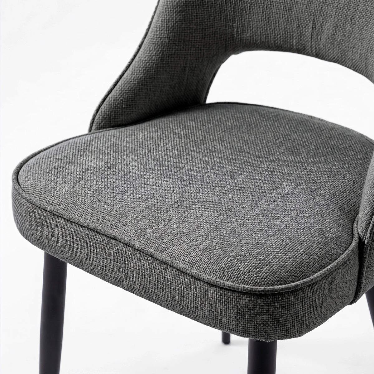 [Grey] Close-up of Kyvon 4-seater grey upholstered fabric comfy curve chair seat with black metal legs