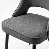 [Grey | Tinted] Close-up of the 4 seater Kyvon grey upholstered fabric comfy chair seat with black metal legs