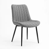 [Vertical Grey | Clear] Kyvon grey upholstered fabric channeled stitched dining chair angled view with black metal legs