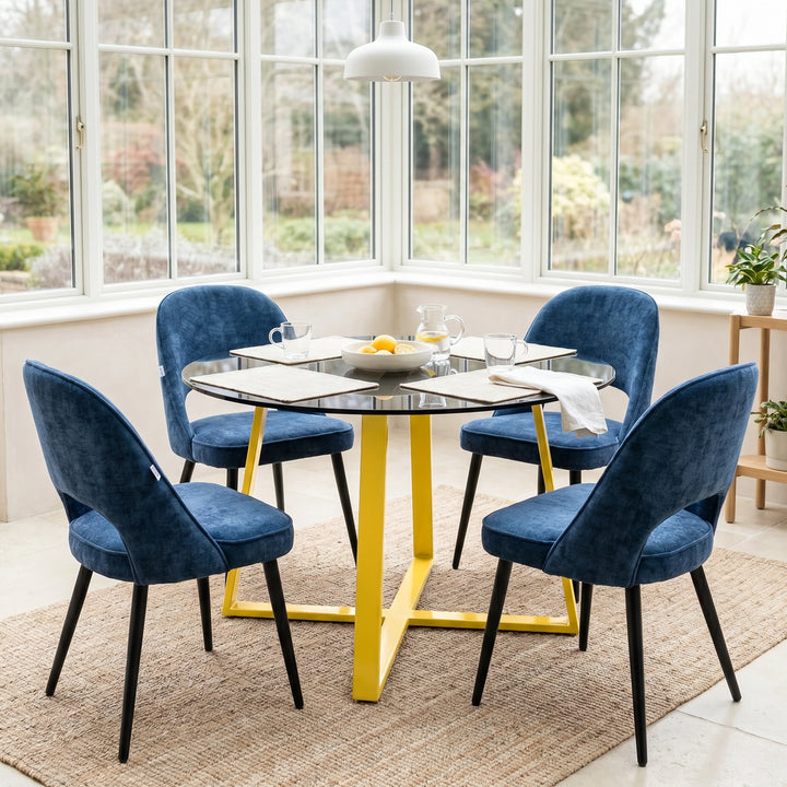 [Blue | Tinted] Kyvon round glass dining table set with comfy curvy chairs and golden iron legs in a conservatory
