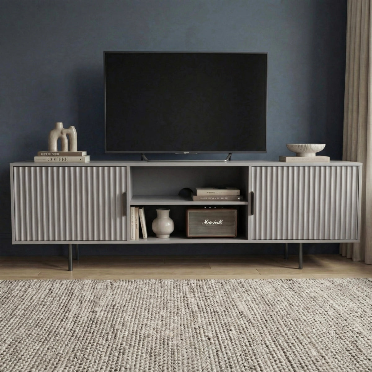 [Grey] Grey 180cm TV unit with vertical fluted side doors and central open shelf, TV mounted on dark navy wall.