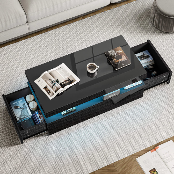 [Black] Overhead view of black storage coffee table with both side drawers extended showing books and magazine inside