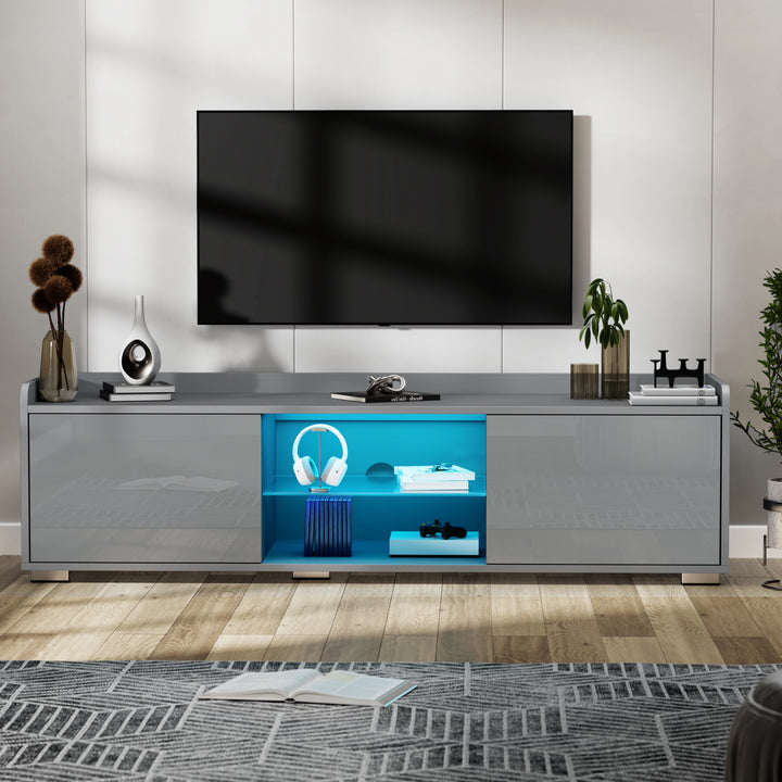 [Grey] grey high gloss TV unit below wall TV with blue LED-lit central shelves displaying headphones
