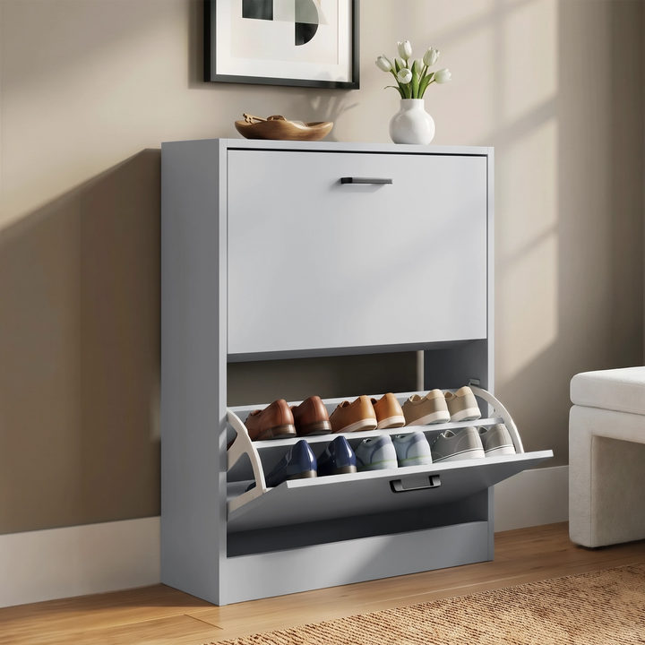 [Light Grey] Angled hallway view with lower drawer open, shoes on tilted shelves, top decor, framed art, rug, and bench