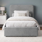 [Light Grey | Small Double] velvet upholstered bed frame with a tall headboard, shown in a styled bedroom setting with white bedding, a beige throw blanket, a nightstand, and a blue-gray wall.