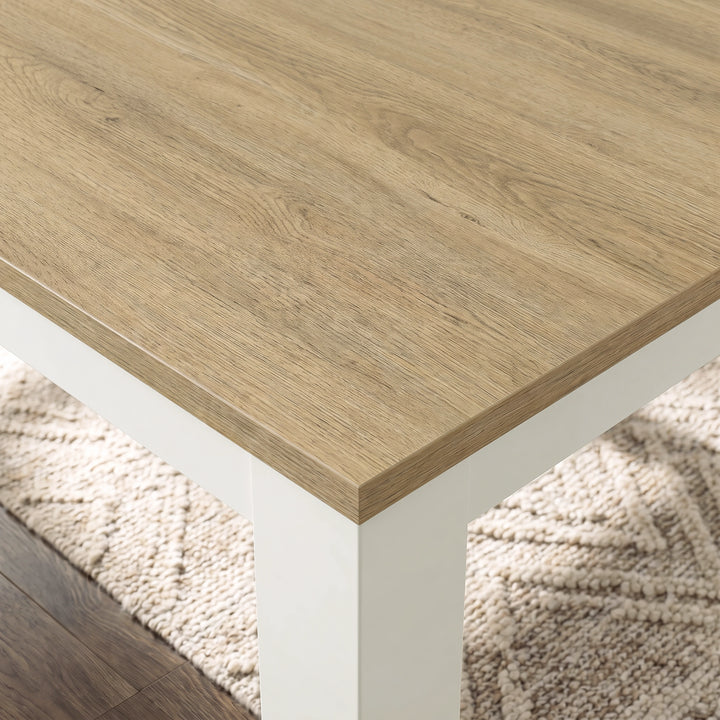 [160cm | Light Oak] Close-up of Light Oak-grain extendable tabletop, layered edge, white frame and thick square leg above a cream rug.