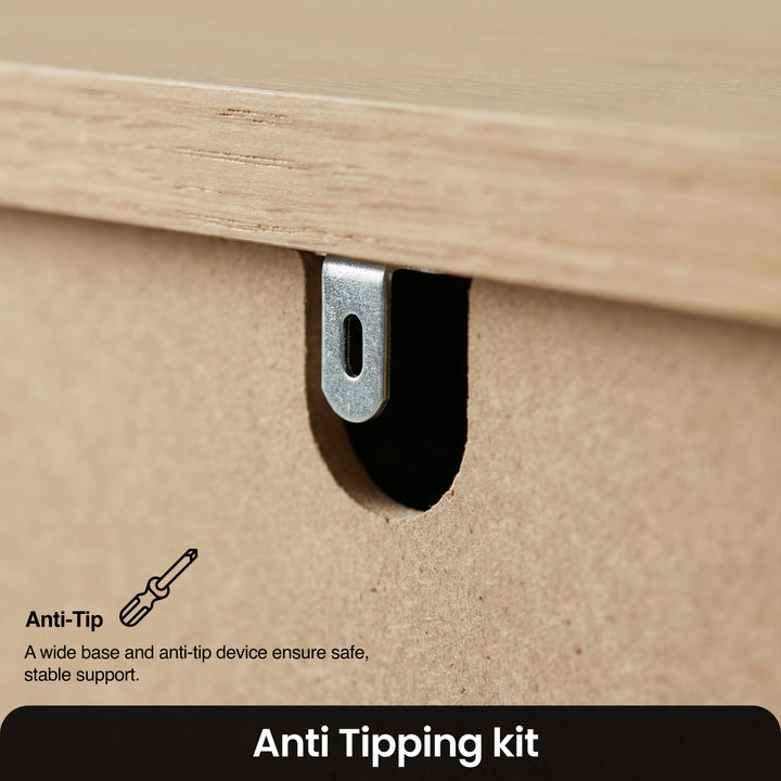 [Blue] Anti-tip wall safety bracket on back of Linra chest of drawers with arrow showing wall fixing position