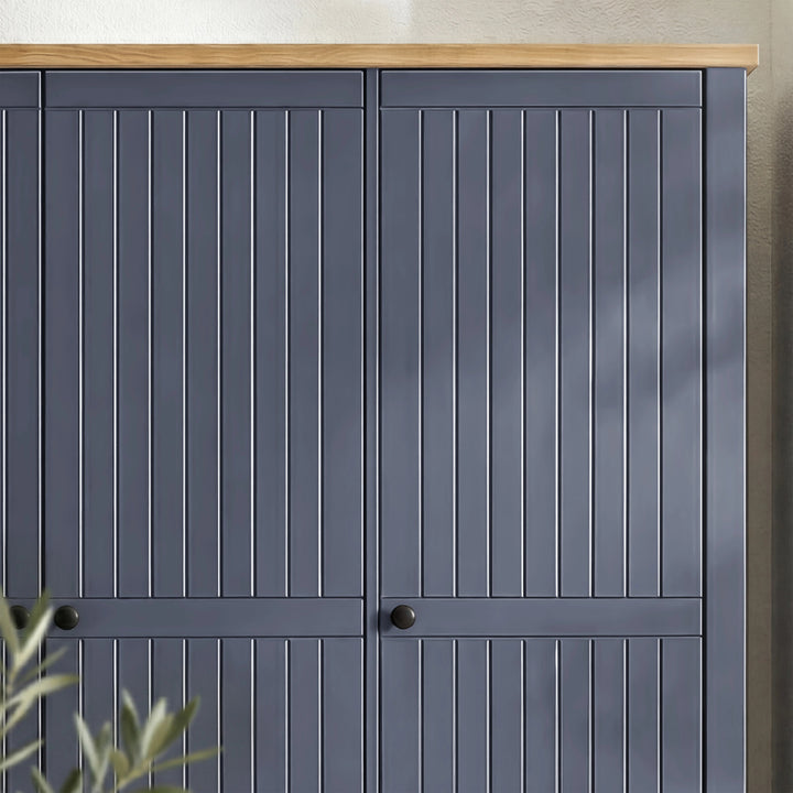 [Blue] Linra wardrobe lower corner detail showing tapered painted leg under base drawer panel