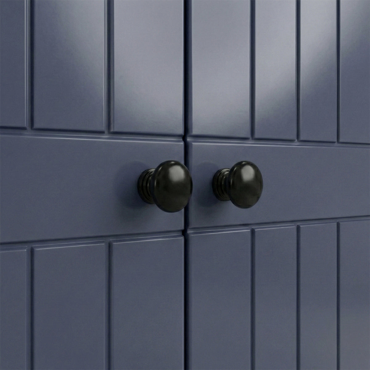 [Blue] Close-up brass round knob on Linra wardrobe drawer front showing grooved panel below