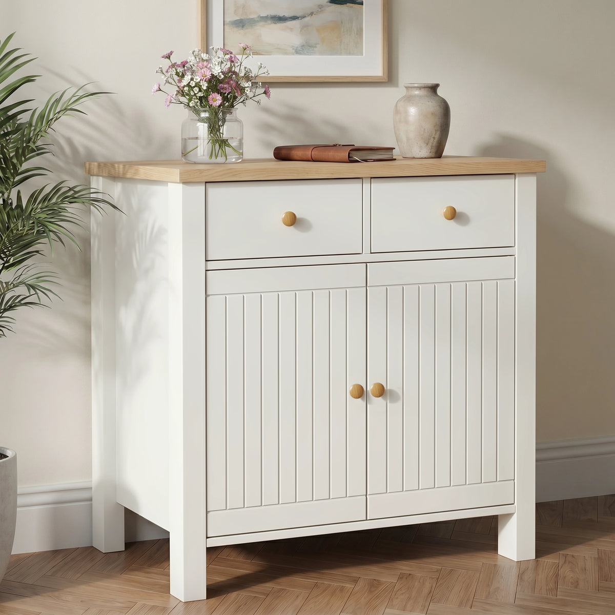 [White] Linra sideboard in a hallway living space styled with ceramic lamp, decorative vases, stacked books, and gallery wall artwork