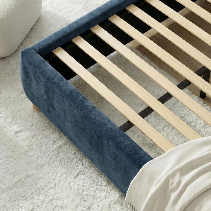 [Blue | Double] Close-up of slat system fitted inside velvet frame with boucle pouf and white shag rug visible nearby
