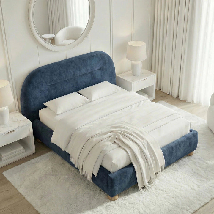 [Blue | King] Overhead corner view showing full velvet bed footprint with white bedding and fringed throw on cream rug