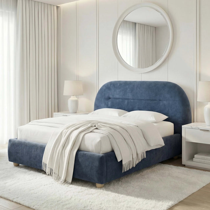 [Blue | King] Angled view of upholstered bed frame revealing headboard depth beside floating nightstand and ceramic lamp