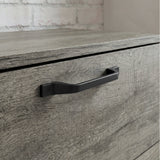 [Wooden Grey] Millwright chest of drawers close-up showing black handle on wooden grey drawer front