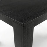 [6 Seater | Black] Close-up of the Milo black wood-effect tabletop edge, grain, and inverted L-shaped table leg