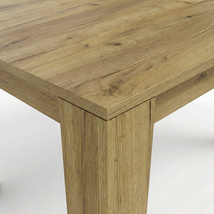 [8 Seater | White] Close-up of the Milo oak-effect tabletop corner, wood grain, and inverted L-shaped table leg