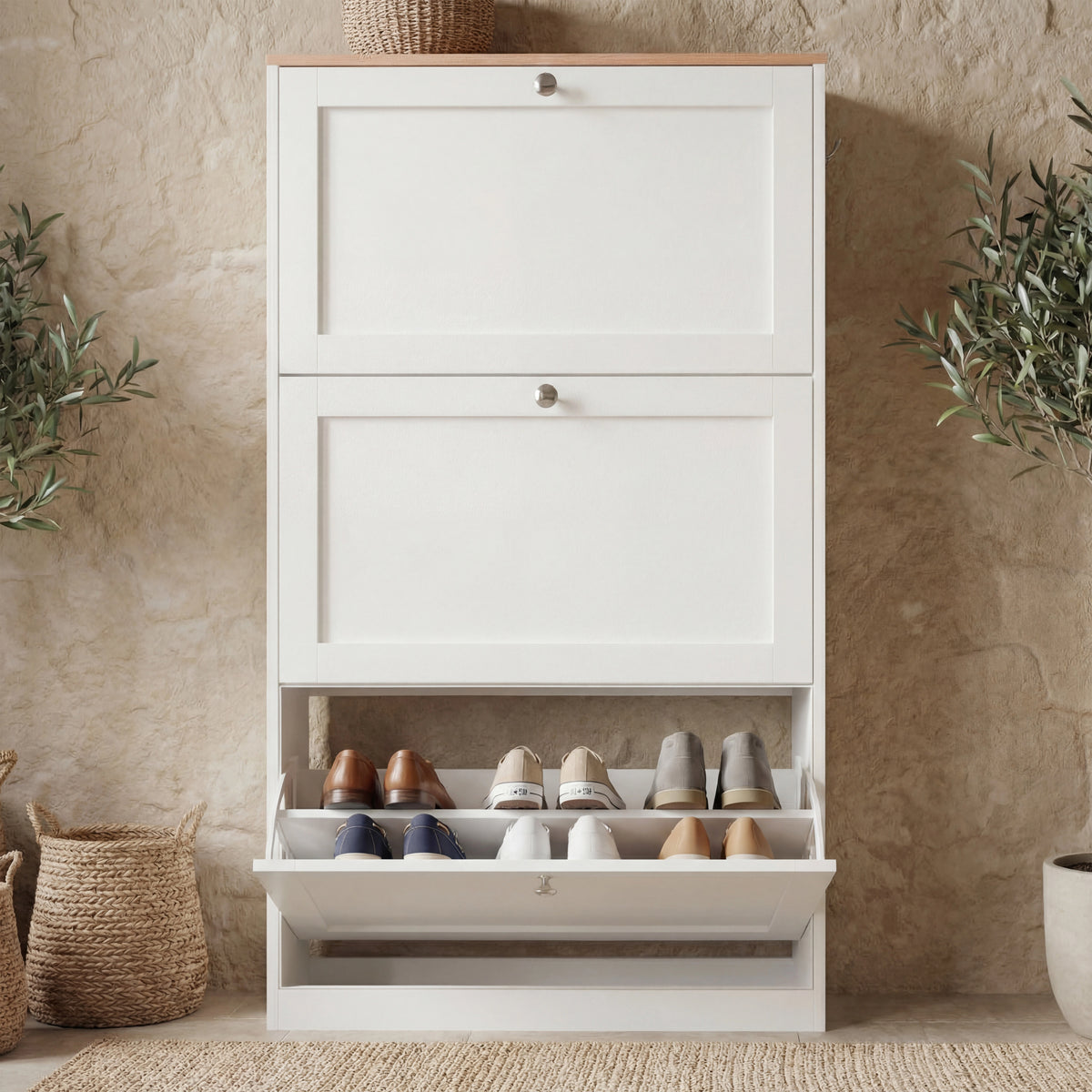 [White] shoe storage unit front elevation with three flip-front doors, lowest drawer tilted open revealing two-tier shoe rack