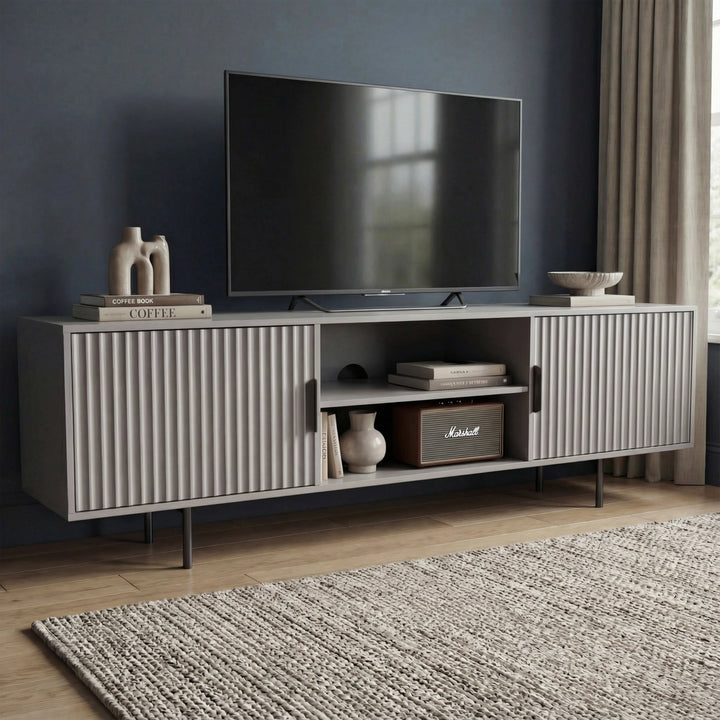 [Grey] Angled grey 180cm TV unit with mounted TV on navy wall, Marshall speaker and ceramic vase on central open shelf.