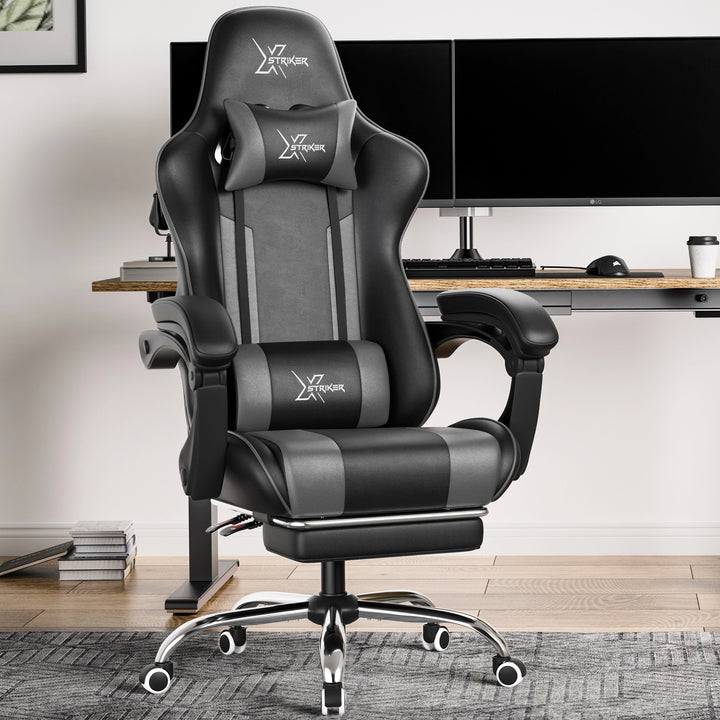 [Black + Grey] Xstriker Gaming Chair With Footrest in black and grey, featuring ergonomic lumbar support and headrest, placed in a modern home office setup.