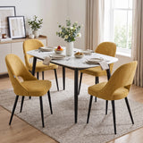 [Mustard | Set of 4] Four upholstered comfy dining chairs at a white table set for four styled with fruit and a flower vase.