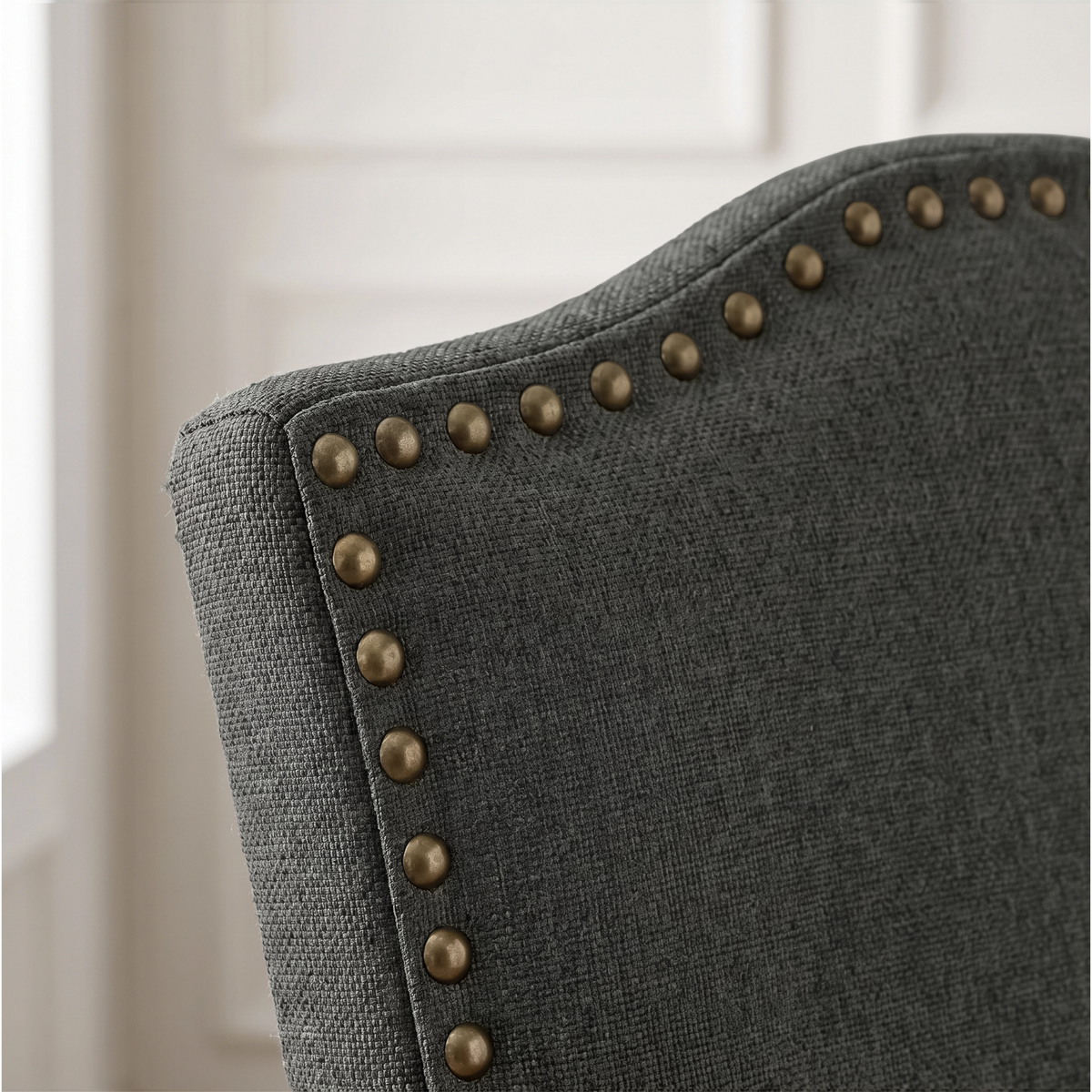 [Dark Grey | Set of 2] Close-up detail of bronze nailhead trim on Dark Grey fabric dining chair back.