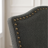 [Dark Grey | Set of 4] Close-up detail of bronze nailhead trim on Dark Grey fabric dining chair back.