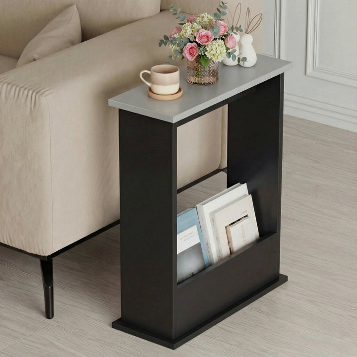 [Grey + Black] black body grey top slim side table between beige seating with flowers and books in slot
