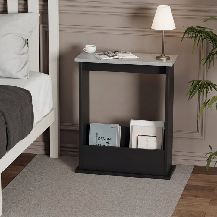 [Grey + Black] grey top black side table styled as bedside next to white bed with reading lamp