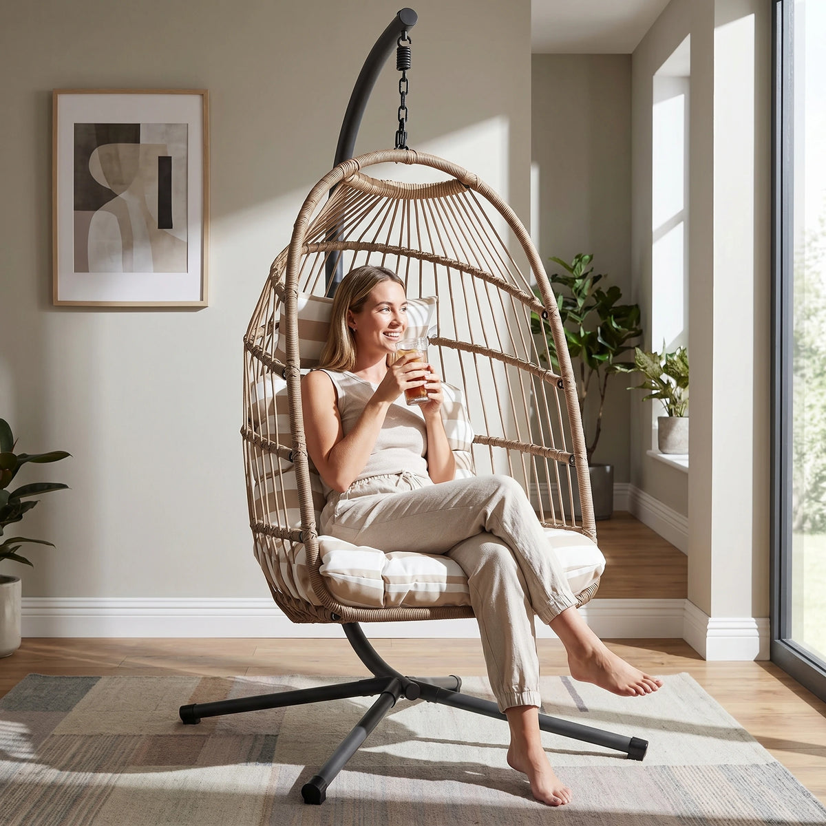 [Natural] foldable garden egg chair with cushion indoors with woman relaxing by sipping coffee
