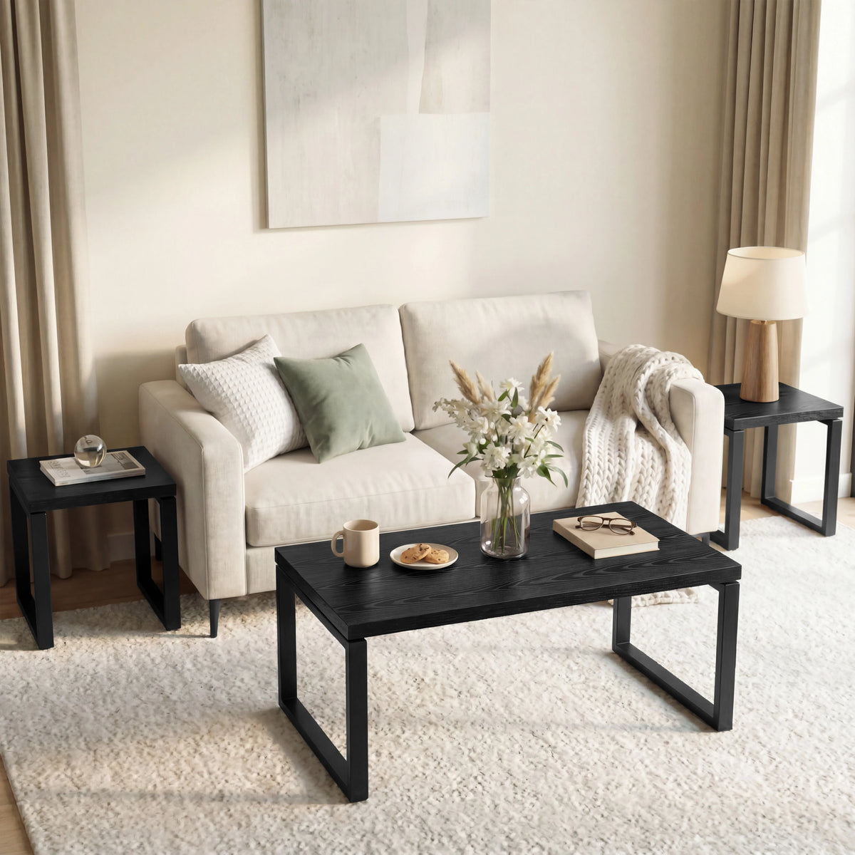 [Black] Nestline nesting coffee table set styled in a soft room with beige chairs, curtains, framed art, and rug