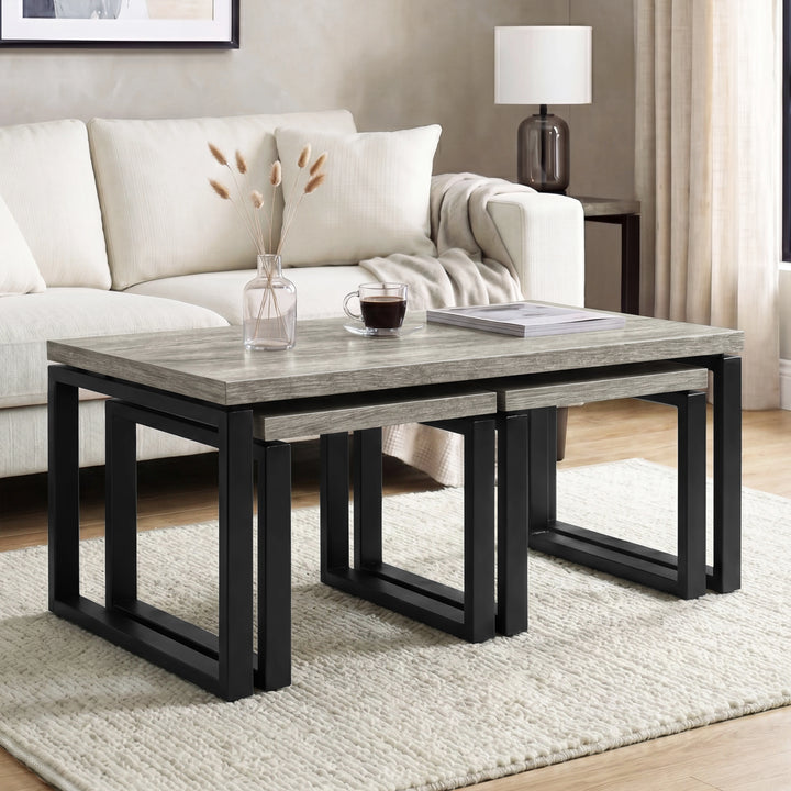 [Grey ] Nestline nesting coffee table in a bright lounge with cream sofa, vase stems, and nested sofa side tables below
