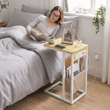 [Oak] side table beside bed with oak-effect top, charging station, lamp, phone and storage pouch