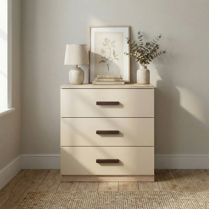 [Oak + Cashmere] Front view of oak cashmere bedroom drawers placed against light wall with black wooden handles in a room