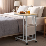 [Oak] side table beside bed with oak-effect top, side pouch storage, snacks and rolling caster wheels