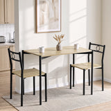 [Oak] Bright kitchen lifestyle view with the two-chair table set, two mugs, dried grass vase and framed wall art