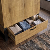[Oak Effect] Rustvale drawer detail showing folded clothes, wash bag, books, rolled socks, metal runners, and rug.