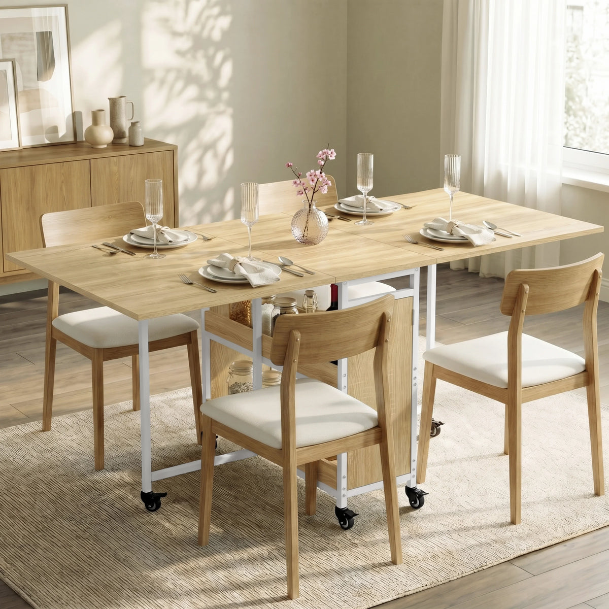 [Sonoma Oak] Stovra dining scene with oak effect table surface, white frame, central shelves, cupboard, and casters