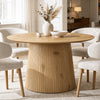 [Oak] round pedestal dining table in room with slatted pedestal base and cream chairs
