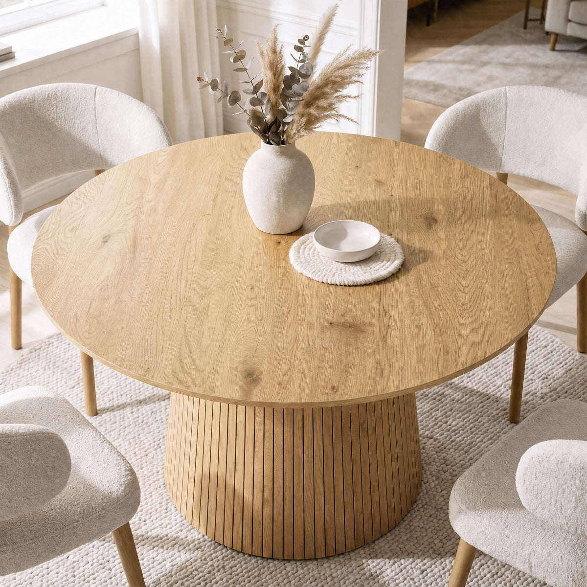 [Oak] Top view of round pedestal dining table with cream chairs and tableware