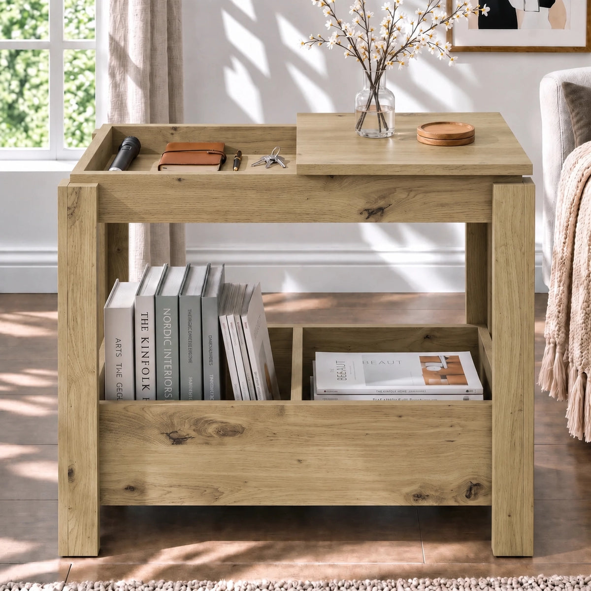 [Oak] Front view of a side table with one top compartment open, a vase on the other panel and books stored underneath.