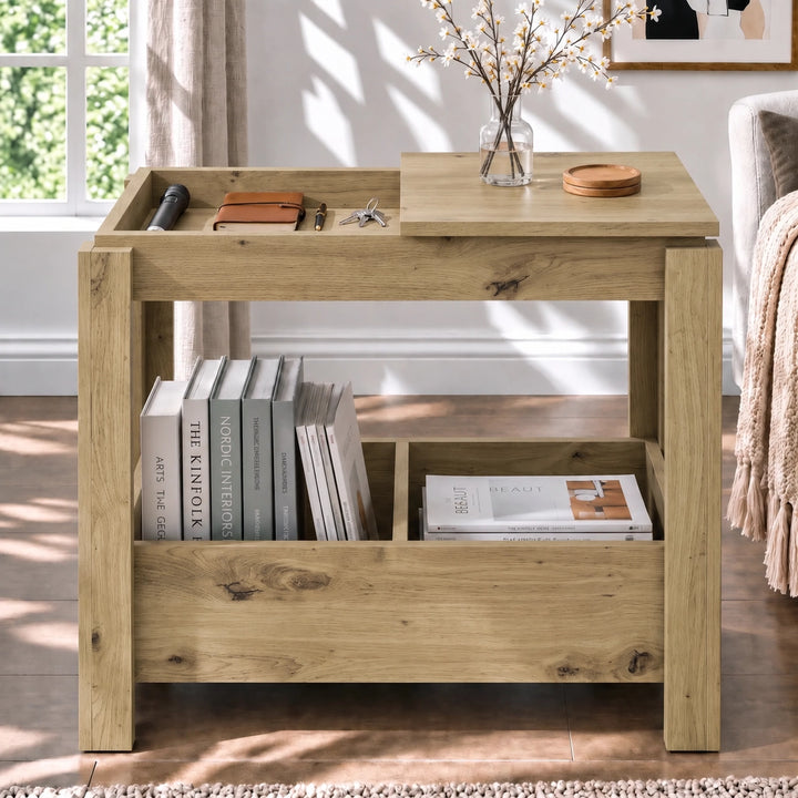 [Oak] Front view of a side table with one top compartment open, a vase on the other panel and books stored underneath.