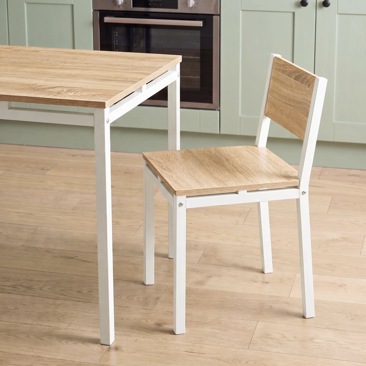 [Pine] Breakfast table edge & chair close-up with wood-effect panels, square grey metal frames, support rails & visible bolts