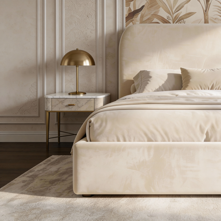[Double | Beige] Side angle of Pluva ottoman bed showing curved headboard profile and clean velvet base beside nightstand