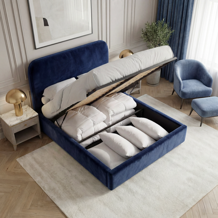 [Double | Blue] Storage cavity of Pluva ottoman bed open showing white pillows duvets and accent armchair beside