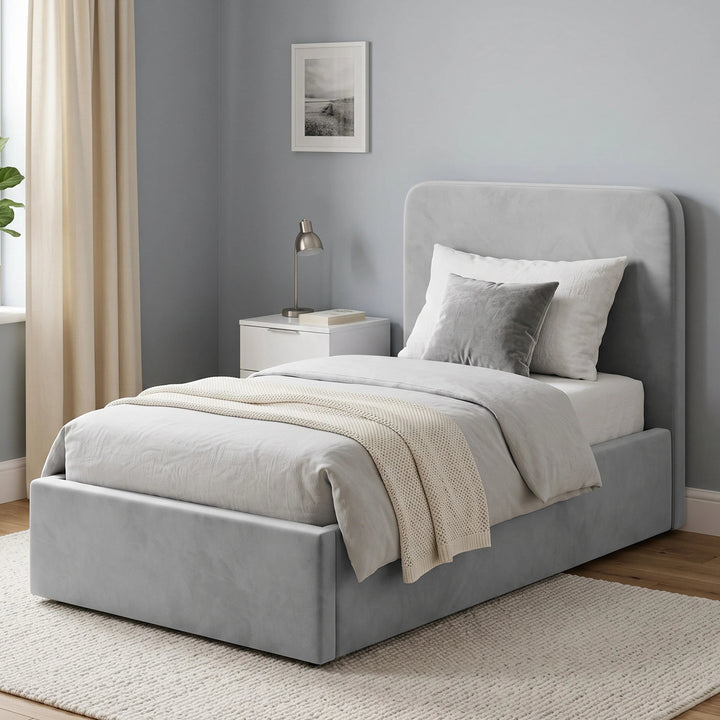 [Single | Light Grey] Closer bedroom angle with rounded headboard, white pillows, bedside cabinet and curtain