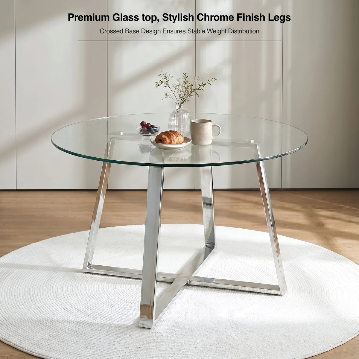 [Clear] Round glass dining table with chrome legs and a crossed base for stable weight distribution, styled for breakfast.
