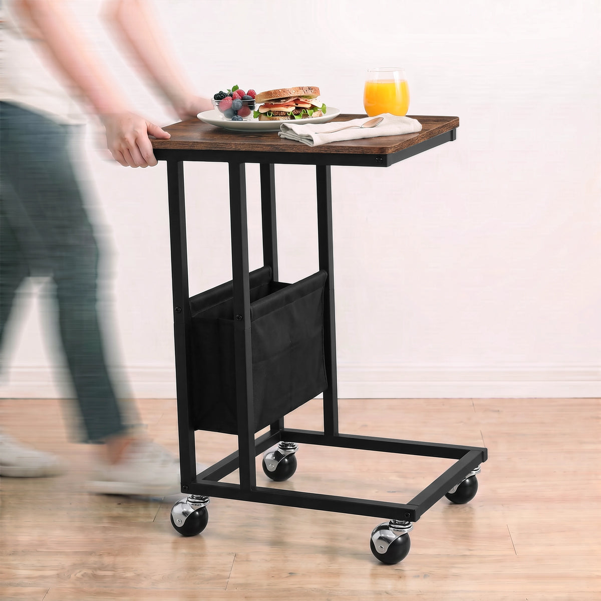 [Rustic] movable side table being rolled on caster wheels with snacks and drink on tabletop