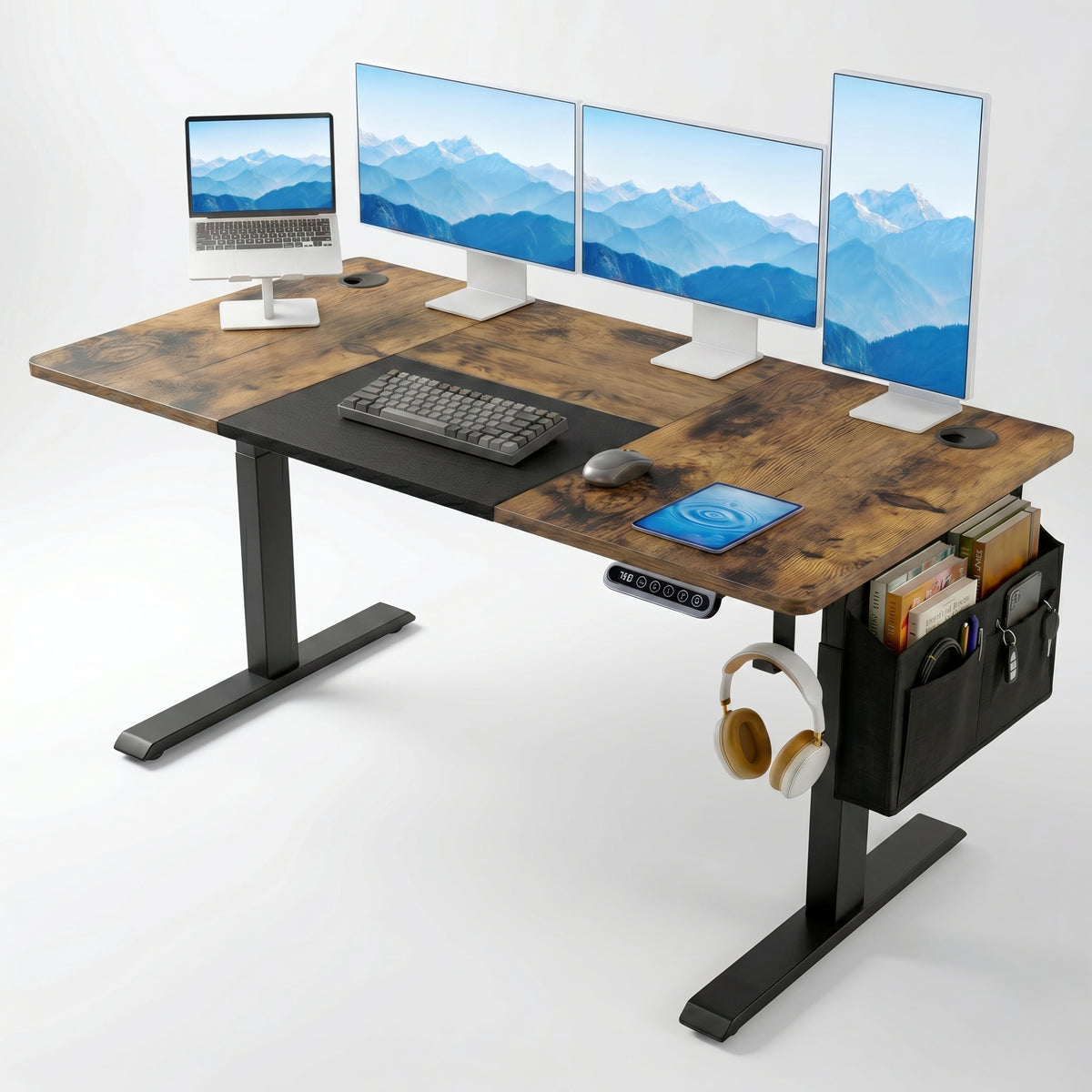 [160cm x 70cm] Rustic Electric Standing Desk with dark wood top, three monitors, laptop stand, mechanical keyboard, tablet, side organiser, and headphones
